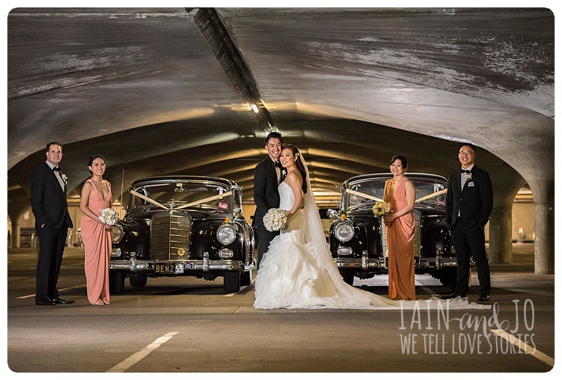 The bridal party with cars provided by TripleR Cars, in the carpark at Melbourne University