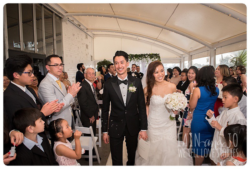 The happy couple walk back down the aisle to celebrate with their family and friends