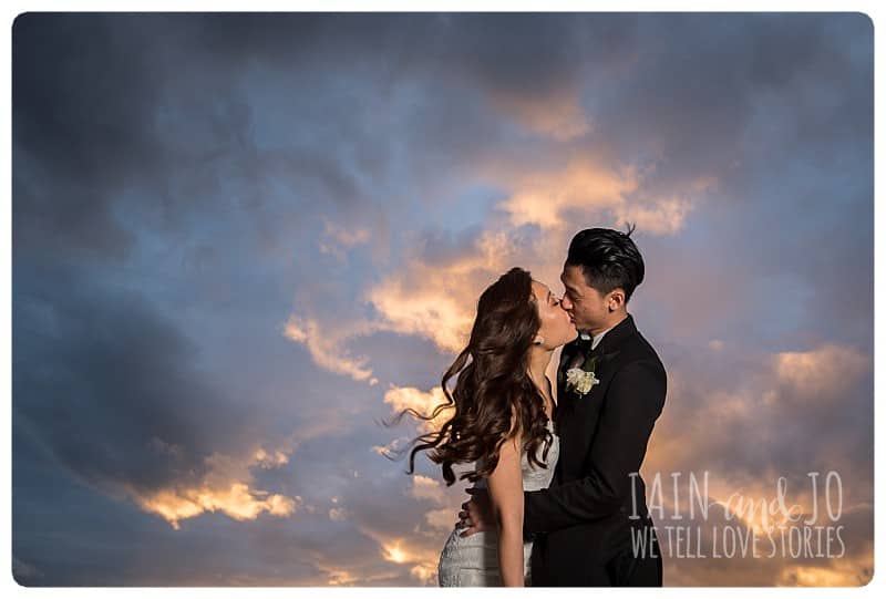 Bride and groom sharing a kiss at sunset in Albert Park