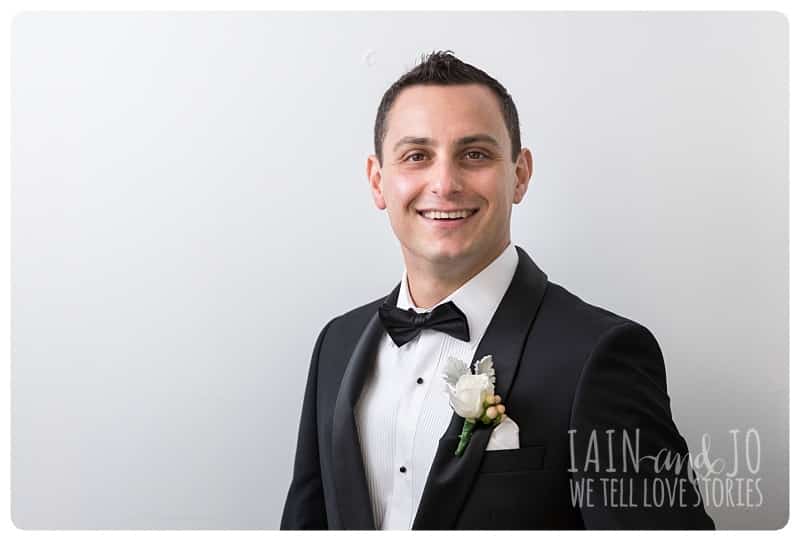 Groom Wearing His Coat Solo Picture of the Groom