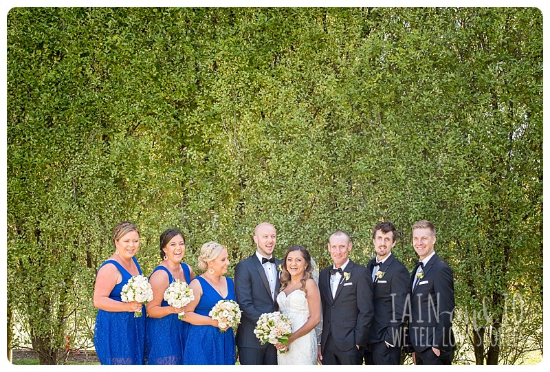 Bridesmaids and groomsmen posing with groom