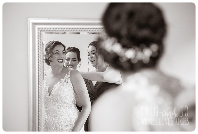 Bridesmaids helping bride get ready