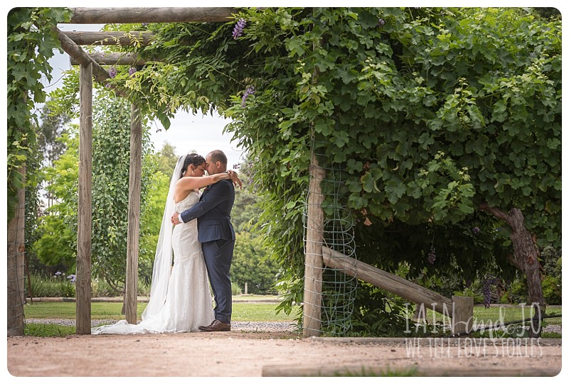 Bride and groom under archway