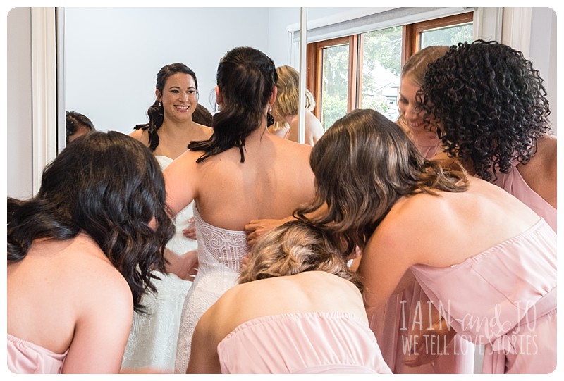 Bridesmaids helping bride get ready